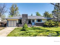 Charming ranch-style home with a well-manicured front lawn and inviting blue door at 3735 Britting Ave, Boulder, CO 80305