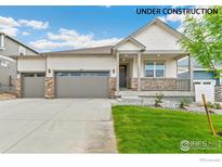 Charming single-story home with a two-car garage, stone accents, and a welcoming front porch at 4708 Windmill Dr, Brighton, CO 80601