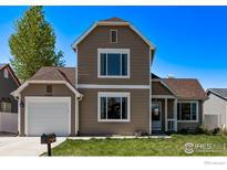 Charming two-story home with a well-maintained front yard and attached one car garage at 5298 S Zeno Way, Centennial, CO 80015