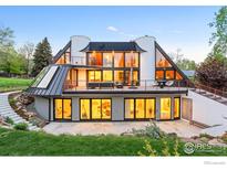 Unique home featuring walls of windows, rooftop balconies, and lush landscaping in a serene setting at 630 Northstar Ct, Boulder, CO 80304