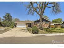 Charming brick home featuring a well-maintained lawn and mature shade trees at 10723 Loren Ln, Northglenn, CO 80233