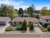 Charming ranch-style home with mature landscaping, an attached garage, and inviting curb appeal at 1650 Bedivere Cir, Lafayette, CO 80026