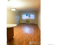 Spacious living room with hardwood floors and natural light at 2295 E Asbury Ave # 205, Denver, CO 80210