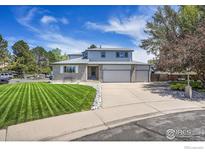 Beautiful two-story home featuring a well-manicured lawn and three-car garage at 2410 Key Ct, Longmont, CO 80501