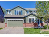 Charming two-story home with a green exterior, well-maintained lawn, and an attached two-car garage at 3117 Cimarron Pl, Superior, CO 80027