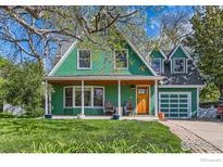 Charming two-story home featuring a covered front porch, garage, and well-manicured lawn at 485 Grape Ave, Boulder, CO 80304