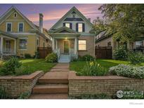 Charming two-story home features a well-manicured lawn and beautiful landscaping at 486 N Corona St, Denver, CO 80218