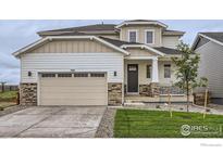 Charming two-story home boasts a two-car garage and inviting front porch at 5881 Aspenglow St, Longmont, CO 80504