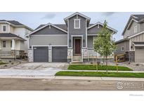 Charming two-story home with a two-car garage, landscaped yard, and inviting front porch at 5891 Aspenglow St, Longmont, CO 80504