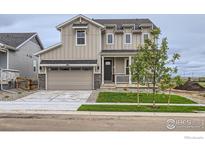 Charming two-story home featuring a two-car garage and a welcoming front porch at 5901 Aspenglow St, Longmont, CO 80504