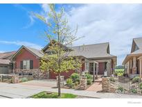 Charming single-Gathering home with a beautifully landscaped front yard and inviting entryway at 1130 Summit View Dr, Louisville, CO 80027