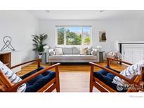 Bright living room with stylish seating and large windows framing picturesque mountain views at 1350 Lehigh St, Boulder, CO 80305
