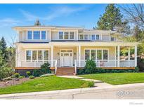 Charming two-story home with a welcoming front porch, landscaped lawn, and classic architectural details at 1380 Bluebell Ave, Boulder, CO 80302