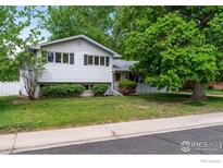 Charming home featuring a well-maintained lawn and mature trees enhancing the curb appeal at 1429 Linden St, Longmont, CO 80501