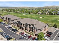 Spacious apartments boast manicured landscaping, ample parking, and views of the adjacent green golf course at 3095 Blue Sky Cir # 305, Erie, CO 80516