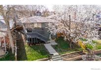 Charming home with a large flowering tree and landscaped front yard and inviting entrance at 3233 Meade St, Denver, CO 80211