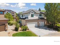 Two-story home with a three car garage, neutral siding and brick accents at 3931 Stonegrass Pt, Broomfield, CO 80023