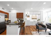 Modern kitchen featuring stainless steel appliances, dark countertops and beautiful bar stool seating at 4555 13Th St # 2C, Boulder, CO 80304