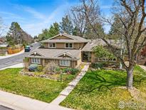Well-maintained two-story home with lush lawn, mature trees, and inviting curb appeal on a sunny day at 4961 W 98Th Ave, Westminster, CO 80031