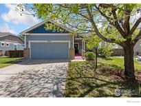 Charming single-Gathering home with a well-manicured lawn and a two-car garage at 6054 Ulysses Ave, Firestone, CO 80504