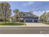 Beautiful two-story home featuring a three-car garage and a well-manicured front lawn at 6212 Saddleback Ave, Firestone, CO 80504