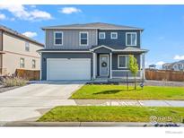 Charming two-story home with a well-maintained lawn, two-car garage and inviting front porch at 902 William Way, Brighton, CO 80603