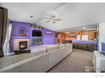 Spacious living room features a fireplace, media center and access to the kitchen at 10818 Cimarron St # 206, Firestone, CO 80504