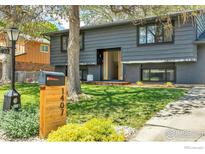 Charming two-story home featuring a well-manicured lawn and beautiful landscaping at 1407 S Terry St, Longmont, CO 80501