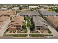 A charming neighborhood boasting well-maintained townhomes, landscaping, and a serene, pedestrian-friendly walkway at 1456 Sepia Ave, Longmont, CO 80501