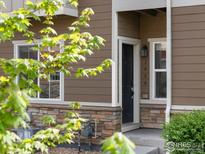 Charming home exterior features a stone accent and a welcoming front door at 1456 Sepia Ave, Longmont, CO 80501