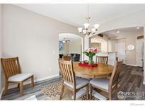 Bright dining room with stylish chandelier and dining table at 1705 Wales Dr, Berthoud, CO 80513
