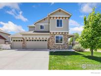 Charming two-story home with a three-car garage and manicured lawn at 1705 Wales Dr, Berthoud, CO 80513