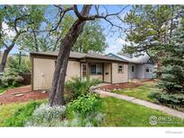 Charming single-story home with a well-maintained lawn, mature trees, and inviting curb appeal at 2022 Ford St, Golden, CO 80401