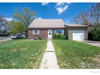 Charming single-story home with brick facade, well-manicured lawn and attached garage, ideal for Gathering living at 2951 W 73Rd Ave, Westminster, CO 80030