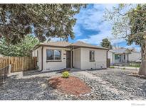 Charming home featuring a brick facade, well-maintained front yard, and inviting walkway to the front door at 3204 S Cherokee St, Englewood, CO 80110