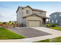 Beautiful two story home with attached garage, landscaping, and modern gray and tan color palette at 360 Marlowe Ct, Erie, CO 80516
