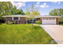 Charming single-story brick home with a well-maintained lawn and mature trees at 4760 Lee Cir, Boulder, CO 80303