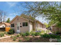 Charming single-story home with a well-maintained yard and blossoming flowers, creating a welcoming curb appeal at 6058 S Hill St, Littleton, CO 80120