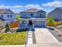 Charming two-story home with stone accents, a covered porch, and a well-manicured lawn on a sunny day at 6506 Merrimack Dr, Castle Pines, CO 80108