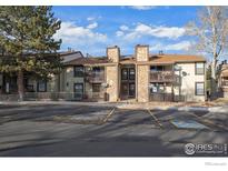 Multi-Gathering property featuring stone accents, wood siding, balconies, and reserved parking at 7820 W 87Th Dr # K, Arvada, CO 80005