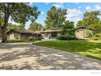 Charming stone home with mature landscaping and a circular driveway offers timeless appeal at 819 Gapter Rd, Boulder, CO 80303