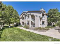 Attractive two-story condo building with lush landscaping and walkways at 1148 Opal St # 101, Broomfield, CO 80020