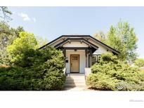 Charming craftsman home with a natural wood front door and landscaped front yard at 1304 9Th Ave, Longmont, CO 80501