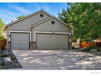 Charming home featuring a two-car garage and well-maintained lawn and landscaping at 1970 Hamron Ct, Erie, CO 80516