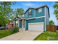 Inviting two-story home with a well-maintained lawn and a two car garage at 200 Mcafee Cir, Erie, CO 80516