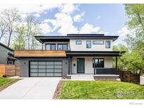 Stunning modern home boasts a stylish facade with sleek lines, large windows, and a spacious attached two-car garage at 2595 Glenwood Dr, Boulder, CO 80304