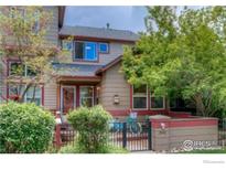 Inviting townhome with manicured landscaping, a cozy front porch, and charming curb appeal at 3648 Oakwood Dr, Longmont, CO 80503