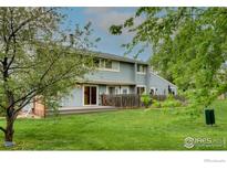 View of the backyard featuring a well-maintained lawn, wooden fence, and patio for outdoor relaxation at 4140 Monroe Dr # C, Boulder, CO 80303
