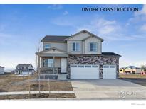 New two-story home featuring stone accents, a covered porch, and a three-car garage at 4204 Sandstone Dr, Mead, CO 80504
