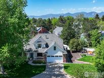 Charming home featuring a landscaped front yard and mountain views in the background at 426 W Spruce Ln, Louisville, CO 80027